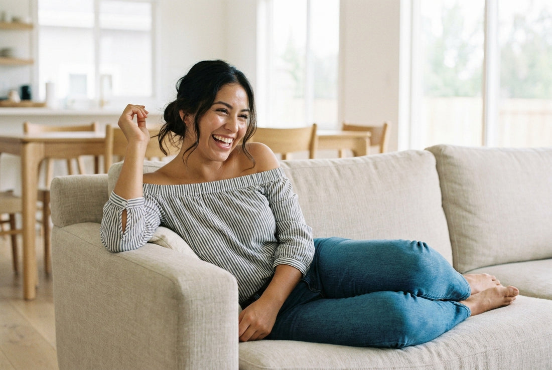 A woman relaxed with a warm mug by a sunny window